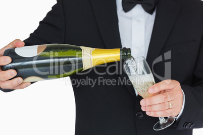 Well-dressed man pouring champagne