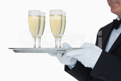 Waiter carrying tray full glasses of champagne