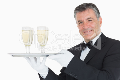 Waiter holding tray with glasses full of champagne