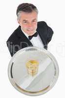 Waiter serving glass of whiskey on a tray