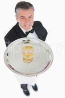 Waiter offering whiskey on tray