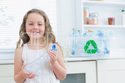 Girl holding plastic bottle