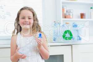 Girl holding plastic bottle