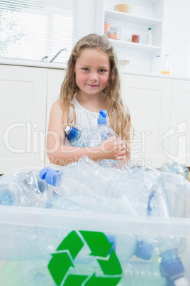 Girl sitting by boxes with plastic