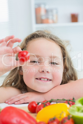 Girl holding cherry tomato