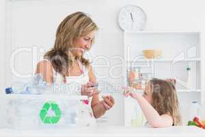 Mother sorting waste with her daughter
