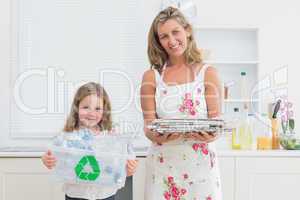 Mother and daughter holding waste