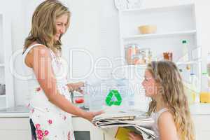 Mother taking newspaper from daughter