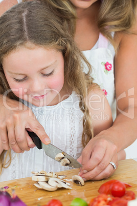 Daughter cutting mushrooms