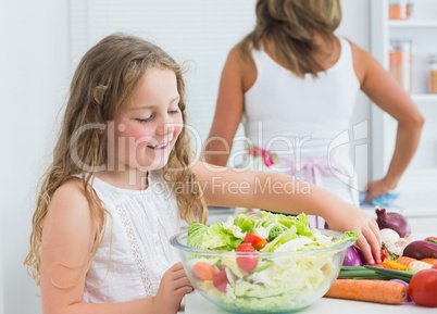 Daughter preparing salad