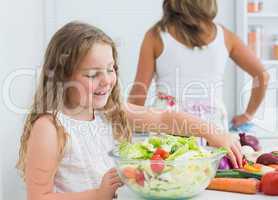 Daughter preparing salad