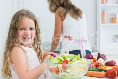 Girl preparing vegetable salad