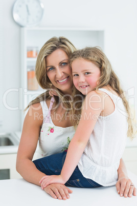 Mother and daughter posing before camera