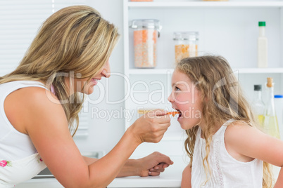 Mother feeding daughter