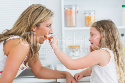 Daughter feeding mother