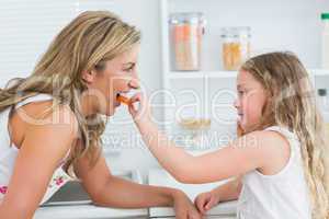 Daughter feeding mother