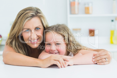 Mother and daughter resting on the table