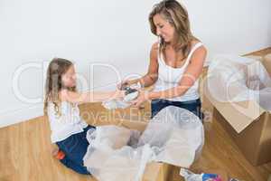 Mother and daughter unpacking things