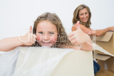 Daughter in box showing thumbs up