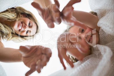 View of mother and daughter giving hands into the box