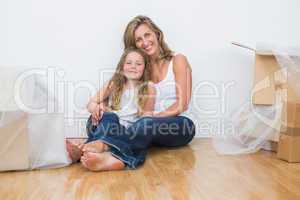 Daughter and mother sitting on the floor