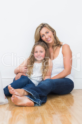 Mother and daughter sitting on the floor