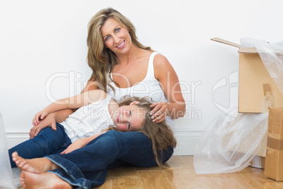 Daughter resting on her mother legs