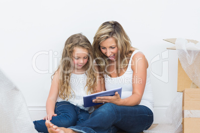 Mother and daughter looking using tablet pc