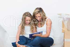 Mother and daughter looking using tablet pc