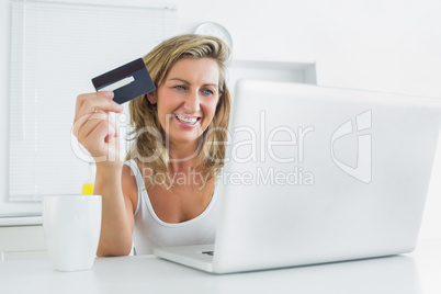 Woman shopping online with laptop