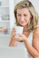 Smiling woman holding mug