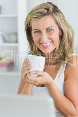 Happy woman holding mug