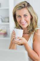 Happy woman holding mug