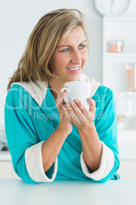 Woman in dressing gown holding cup