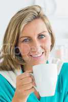 Woman holding cup with hot drink