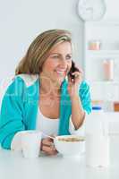 Woman calling during her breakfast