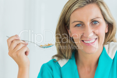 Woman holding spoon of cereal