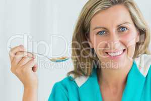 Woman holding spoon of cereal