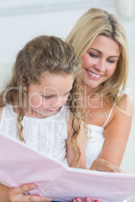 Mother and daughter reading storybook