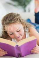 Girl resting on the sofa with book