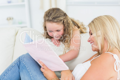 Mother showing something to her daughter