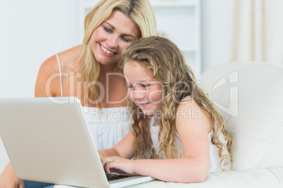 Daughter and mother working with notebook