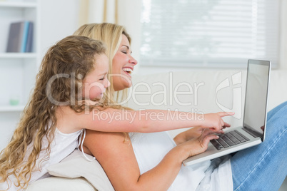 Mother with daughter using laptop