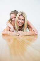 Mother and her daughter resting on the floor