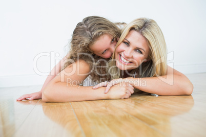 Mother laying with her daughter on the floor