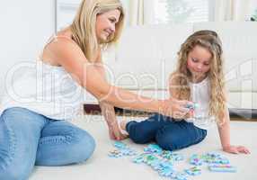 Daughter and mother doing a jigsaw