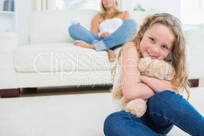 Daughter hugging her teddy bear