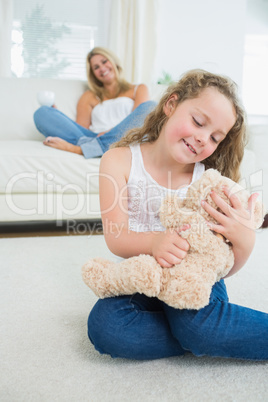 Smiling daughter with her teddy