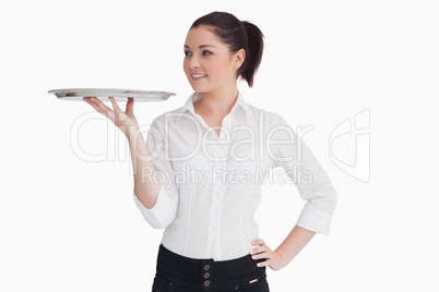 Waitress holding a tray and looking at it