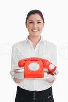 Woman holding a telephone on the tray
